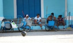 3 Cuban women sitting on doorstep