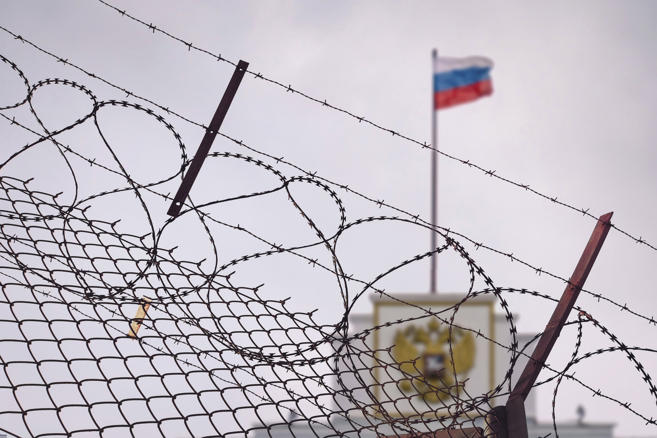 image: concept of European and US sanctions pressure on the Russian Federation government. flag of the Russian Federation in barbed wire, sanctions and aggression of Russia. Russian prison